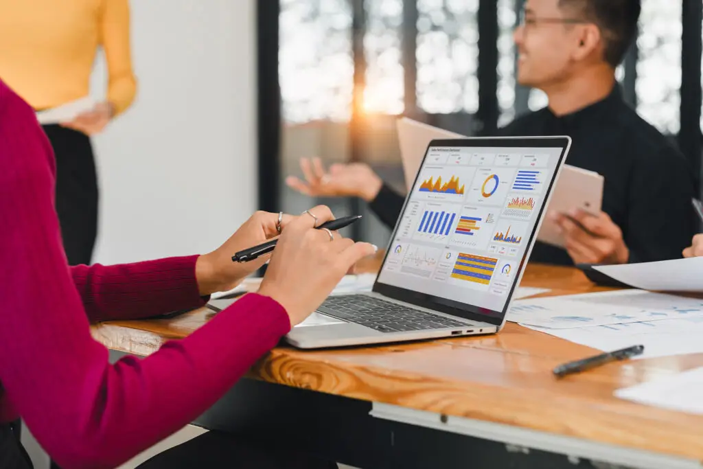 Business professional using laptop with analytics dashboard, representing AI-powered SaaS search